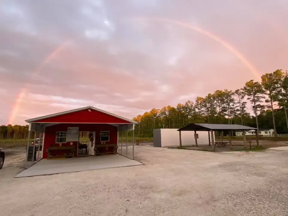 New Hart Farms building & produce stand with rainbow over them